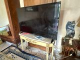 a flat screen tv sitting on a table in a living room