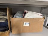 a cardboard box with a lot of clothes in it