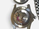a watch that is sitting on a table next to a watch