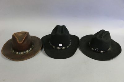 three hats are lined up in a row on a white surface
