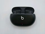 an image of a pair of black earphones sitting on top of a white surface
