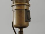 a close up of a wooden object with a metal object on it