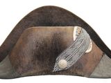 a brown hat with a silver buckle on it