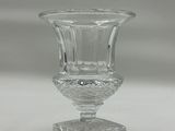 a small glass vase sitting on top of a table