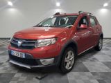 the red dacia is parked in the garage on a checkered floor