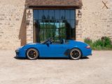 a blue sports car parked in front of a building
