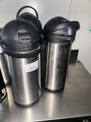 two coffee pots and a coffee maker on a table