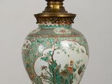 a vase that is sitting on a table with a light on it