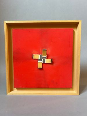 red and gold cross in a wooden frame on a gray background
