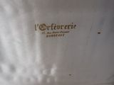 a close up of a white shirt with a brown logo