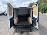 the back of a white van with its doors open in a parking lot