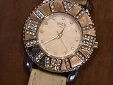 an image of a white watch with diamonds on it on a table