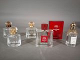 three small bottles of perfume sitting next to each other on a table