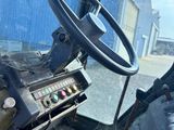 a steering wheel and dashboard of a bus on the street