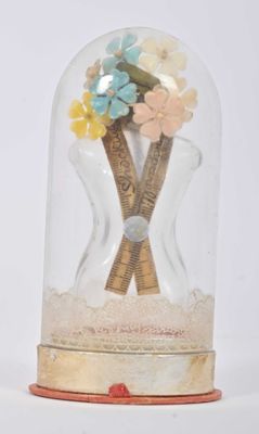 a snow globe with a bunch of flowers inside of it