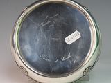 a silver plate with writing on it sitting on a table