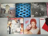 many different album covers on the table together
