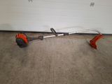an image of a lawn edger in a garage