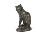 statue of a cat sitting on a rock on a white background