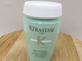 a bottle of kerastasee sitting on a wooden table