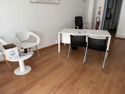 a white table and chairs in a room with wood flooring