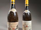 two bottles of wine sitting next to each other on a table