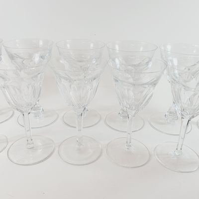 several empty wine glasses are lined up on a white surface
