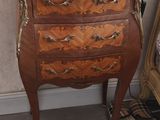 a marble top chest of drawers with a lamp on top of it