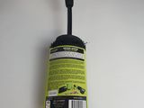 a close up of a black cleaning brush on a white surface