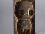 sculpture of a man with a hat on his head holding a knife