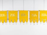 a row of yellow pennants hanging from the ceiling