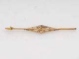 a gold plated broochle with a diamond shaped design