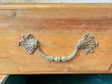 a wooden dresser with a drawer with a drawer handle