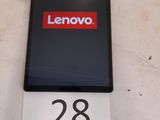 a lenovo phone sitting on a table with a price tag
