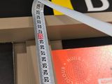 a measuring tape on the edge of a box with a credit card in it