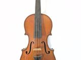 a close up of a violin sitting on a white surface