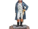 statue d'un homme vêtu d'un manteau bleu et d'un chapeau, debout sur un socle en bois