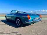 an image of a green convertible car parked in a parking lot