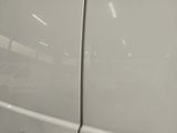 a white van parked in a parking lot with a sign on the side of the van