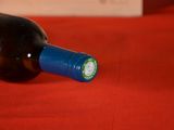 a bottle of wine sitting on a red table cloth