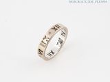 a close up of a silver ring with roman numerals on it