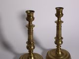 pair of antique brass candlesticks on a white background
