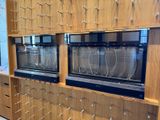 two ovens that are sitting on a shelf in a room