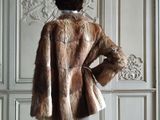 an image of a mannequin wearing a fur coat in a room