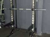 a picture of a gym room with a barbell rack