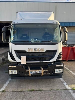 a white truck parked in a parking lot next to a building