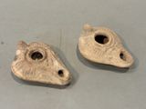 two pieces of clay with holes in them on a table