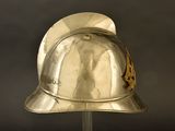 a silver helmet on a stand on a black background