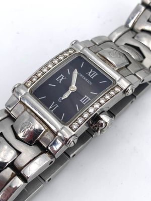 a silver watch with a black face on a silver bracelet