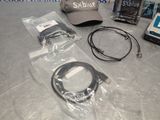a hat, earphones, a cap, and other electronics on a table
